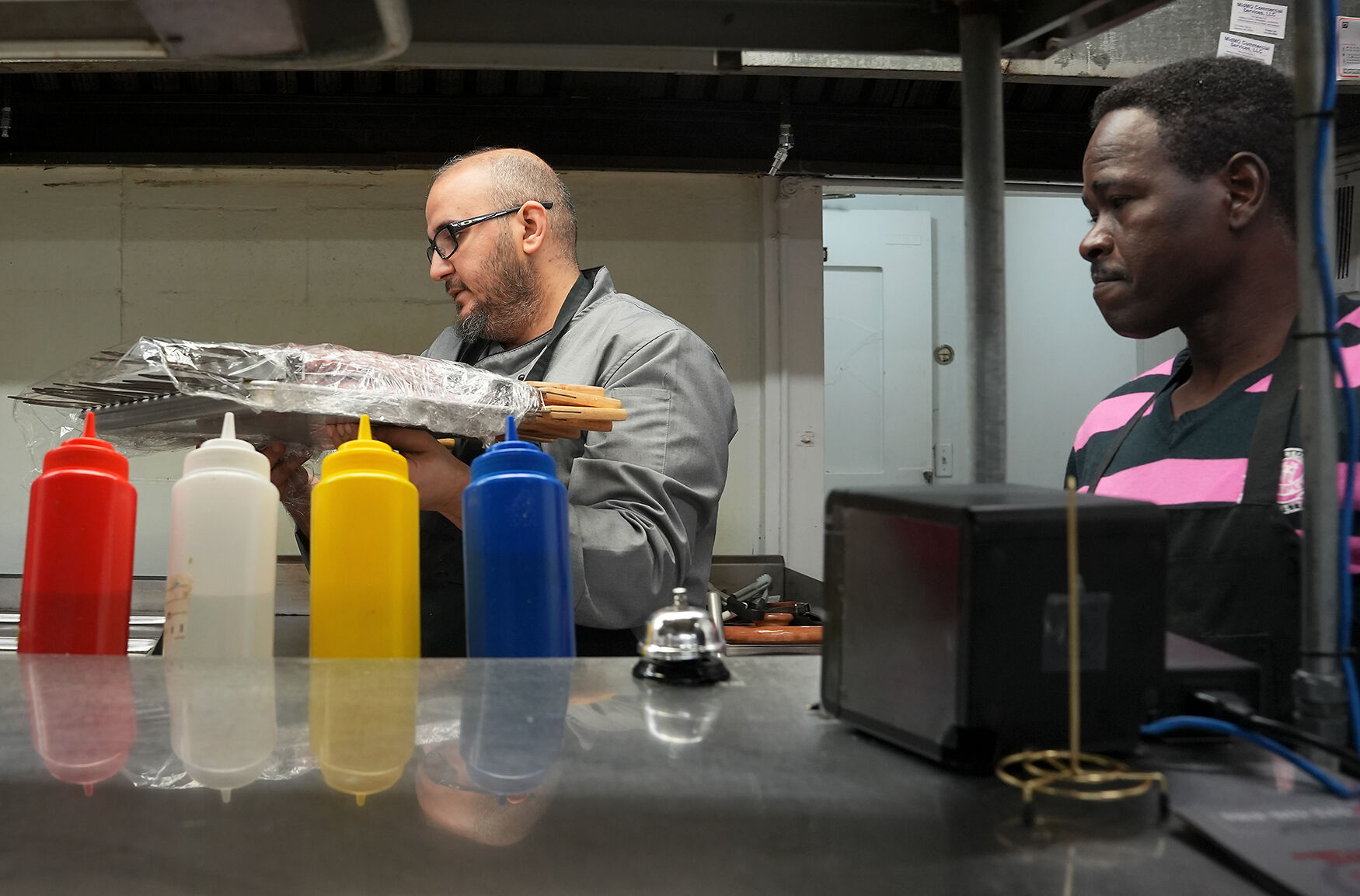 Ahmad Alkadah, left, and Mohammad Mater prepares kebabs for cooking